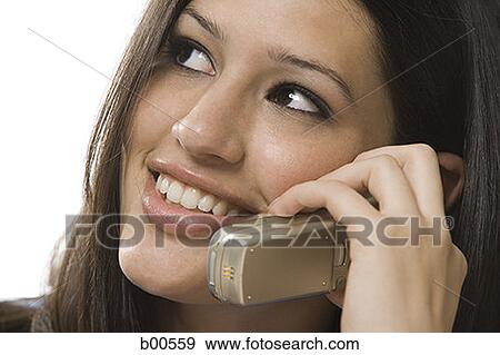 Stock Photo - Close-up of a young woman talking on a mobile phone. Fotosearch