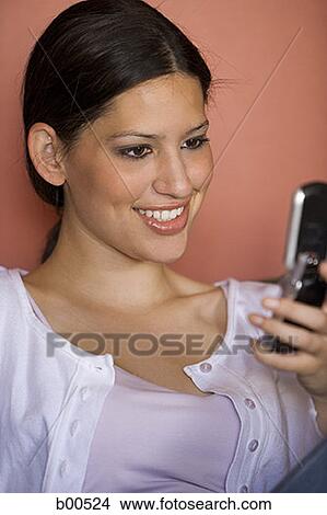 Close-up of a young woman using a mobile phone View Large Photo Image Picture - Close-up of a young woman using a mobile phone. Fotosearch