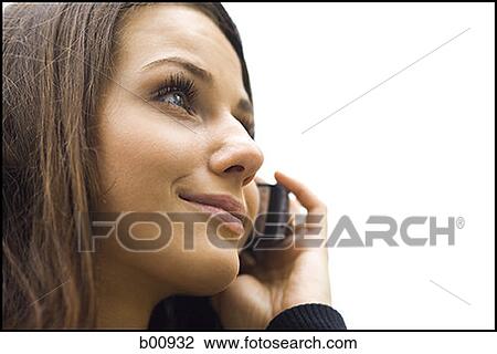 Close-up of a young woman using a mobile phone View Large Photo Image Stock Image - Close-up of a young woman using a mobile phone. Fotosearch