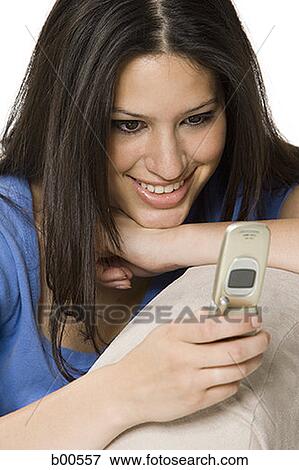 Close-up of a young woman using a mobile phone View Large Photo Image Stock Photo - Close-up of a young woman using a mobile phone. Fotosearch
