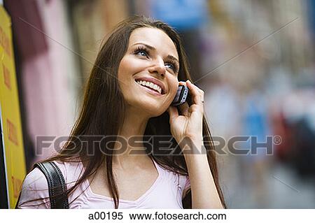 Close-up of a young woman using a mobile phone View Large Photo Image Stock Photography - Close-up of a young woman using a mobile phone. Fotosearch
