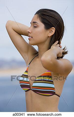 Close-up of a young woman wearing a bikini View Large Photo Image Stock Image - Close-up of a young woman wearing a bikini. Fotosearch