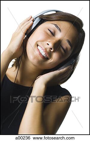 Close-up of a young woman wearing headphones View Large Photo Image Stock Photograph - Close-up of a young woman wearing headphones. Fotosearch