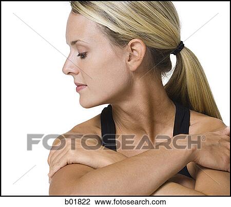 Close-up of a young woman with her arms folded View Large Photo Image Stock Image - Close-up of a young woman with her arms folded. Fotosearch