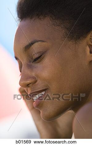 Close-up of a young woman with her eyes closed View Large Photo Image Stock Photo - Close-up of a young woman with her eyes closed. Fotosearch