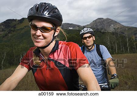Close-up of an adult couple mountain-biking View Large Photo Image Stock Photo - Close-up of an adult couple mountain-biking. Fotosearch