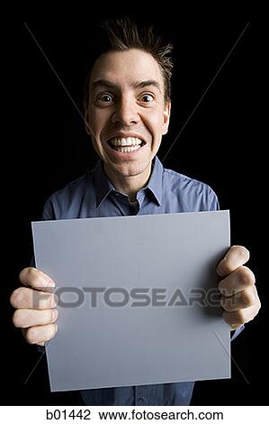 Close-up of an adult man holding a blank sign View Large Photo Image Stock Image - Close-up of an adult man holding a blank sign. Fotosearch