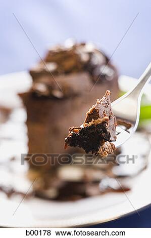 Close-up of chocolate cake on a fork View Large Photo Image Stock Photo - Close-up of chocolate cake on a fork. Fotosearch