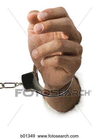 Close-up of hand in handcuffs View Large Photo Image Stock Photo - Close-up of hand in handcuffs. Fotosearch