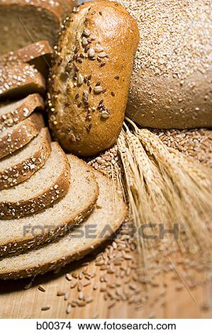 Picture - Close-up of slices of brown bread with wheat. Fotosearch