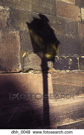 Close-up of the shadow of a street lamp on a stone wall View Large Photo Image Stock Photo - Close-up of the shadow of a street lamp on a stone wall. Fotosearch