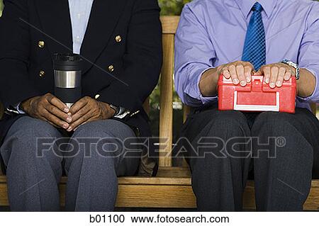 Close-up of two businessmen sitting with a lunch box and a flask View Large Photo Image Stock Image - Close-up of two businessmen sitting with a lunch box and a flask. Fotosearch
