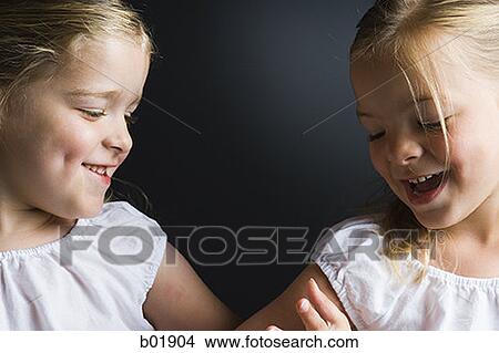 Close-up of two sisters smiling View Large Photo Image Picture - Close-up of two sisters smiling. Fotosearch