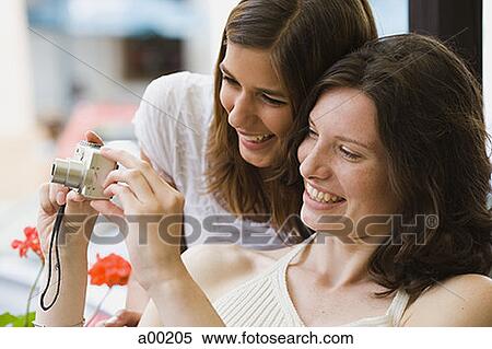 Close-up of two teenage girls looking at a camera screen View Large Photo Image Stock Photography - Close-up of two teenage girls looking at a camera screen. Fotosearch