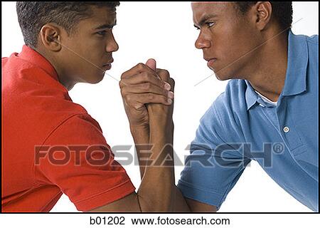 Close-up of two young men arm wrestling View Large Photo Image Stock Image - Close-up of two young men arm wrestling. Fotosearch