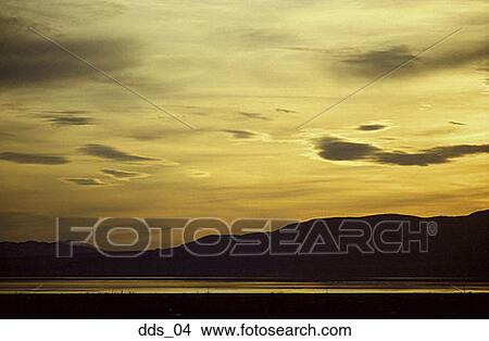 Picture - Clouds over mountains at sunset. Fotosearch