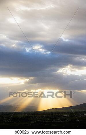 Stock Photography - Dark cloud over a hilly landscape. Fotosearch