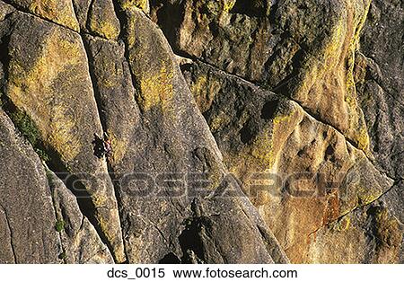 Stock Photography - Distant view of a person rock climbing. Fotosearch