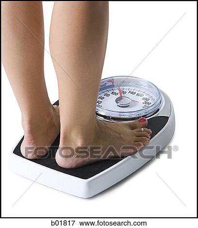 Feet standing on a bathroom scale View Large Photo Image Stock Photo - Feet standing on a bathroom scale. Fotosearch