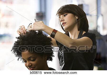 Female hairdresser trimming a young woman's hair View Large Photo Image Stock Photography - Female hairdresser trimming a young woman's hair. Fotosearch