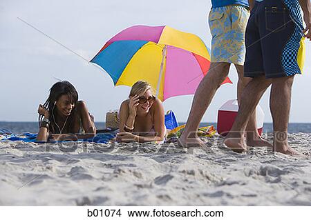 Four young people on the beach View Large Photo Image Picture - Four young people on the beach. Fotosearch