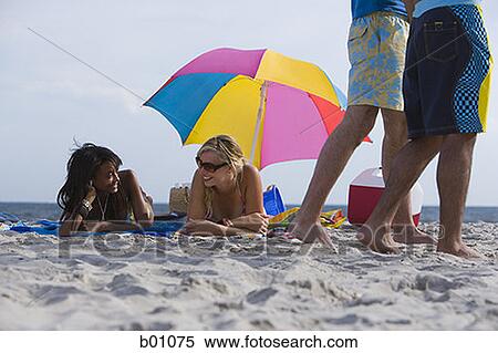 Four young people on the beach View Large Photo Image Stock Photography - Four young people on the beach. Fotosearch