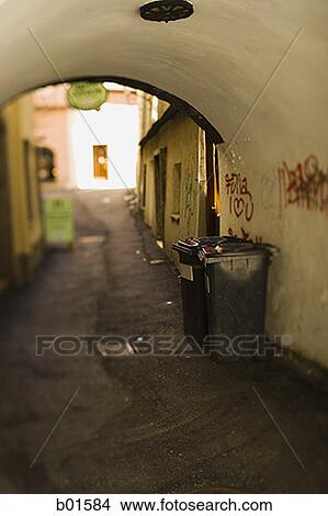 Garbage bin in an empty alley View Large Photo Image Picture - Garbage bin in an empty alley. Fotosearch