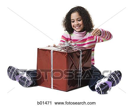 Stock Image - Girl unwrapping a gift. Fotosearch