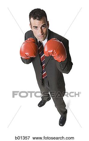 High angle view of a businessman wearing boxing gloves View Large Photo Image Stock Photo - High angle view of a businessman wearing boxing gloves. Fotosearch