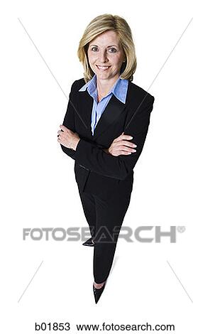 Stock Image - High angle view of a businesswoman standing with her arms folded. Fotosearch