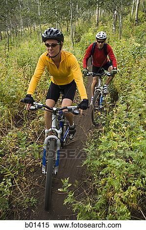 Stock Photography - High angle view of a couple mountain biking. Fotosearch