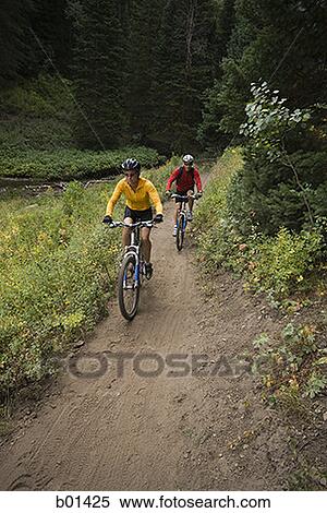 High angle view of a couple mountain biking View Large Photo Image Stock Photography - High angle view of a couple mountain biking. Fotosearch
