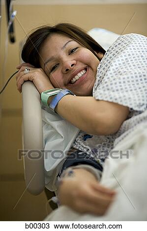 High angle view of a female patient lying on a bed View Large Photo Image Stock Image - High angle view of a female patient lying on a bed. Fotosearch