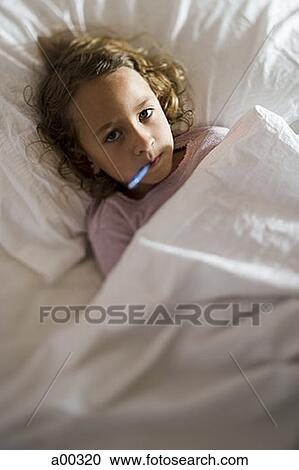High angle view of a girl in a bed with a thermometer in her mouth View Large Photo Image Stock Image - High angle view of a girl in a bed with a thermometer in her mouth. Fotosearch