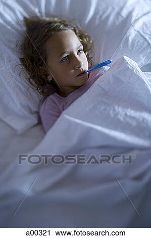 High angle view of a girl in a bed with a thermometer in her mouth View Large Photo Image Stock Image - High angle view of a girl in a bed with a thermometer in her mouth. Fotosearch
