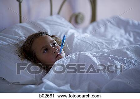 High angle view of a girl with a thermometer in her mouth View Large Photo Image Stock Image - High angle view of a girl with a thermometer in her mouth. Fotosearch