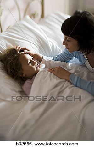 High angle view of a girl with her mother View Large Photo Image Stock Photograph - High angle view of a girl with her mother. Fotosearch