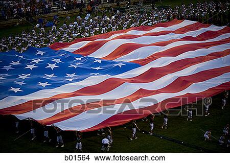 High angle view of a group of people holding a large American Flag View Large Photo Image Picture - High angle view of a group of people holding a large American Flag. Fotosearch