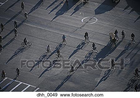 High angle view of a large group of people riding bikes in a street View Large Photo Image Stock Photo - High angle view of a large group of people riding bikes in a street. Fotosearch