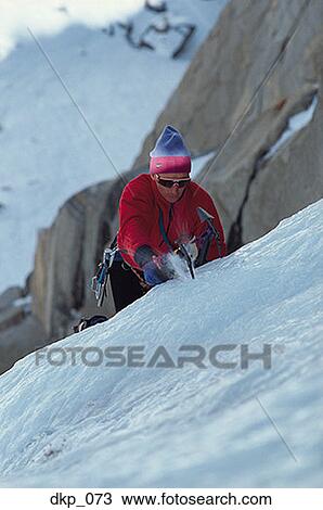 High angle view of a man climbing a snow covered mountain View Large Photo Image Stock Image - High angle view of a man climbing a snow covered mountain. Fotosearch