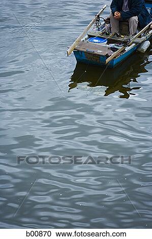 High angle view of a man in a boat View Large Photo Image Stock Image - High angle view of a man in a boat. Fotosearch