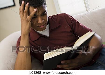 High angle view of a man reading a book View Large Photo Image Stock Photo - High angle view of a man reading a book. Fotosearch
