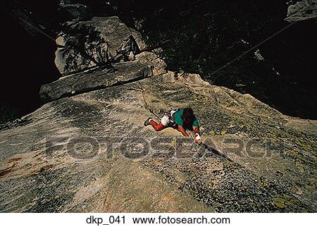 Stock Image - High angle view of a man rock climbing. Fotosearch