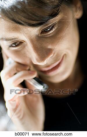 High angle view of a mid adult woman talking on the mobile phone View Large Photo Image Stock Image - High angle view of a mid adult woman talking on the mobile phone. Fotosearch