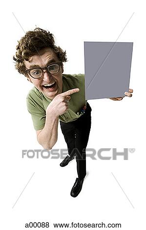 Stock Photo - High angle view of a nerdy young man holding a blank sign. Fotosearch