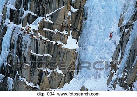 High angle view of a person climbing a snow covered mountain View Large Photo Image Picture - High angle view of a person climbing a snow covered mountain. Fotosearch