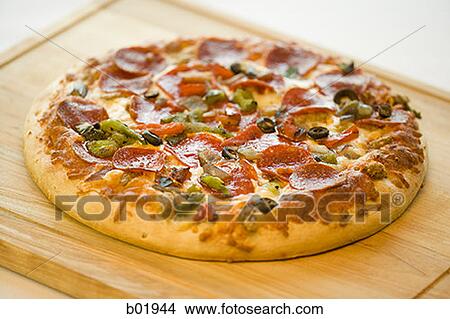 High angle view of a pizza on a cutting board View Large Photo Image Picture - High angle view of a pizza on a cutting board. Fotosearch