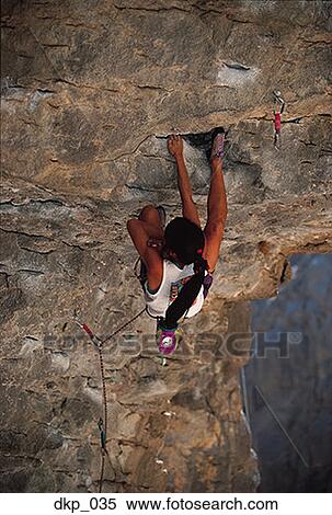 High angle view of a woman rock climbing View Large Photo Image Stock Photography - High angle view of a woman rock climbing. Fotosearch