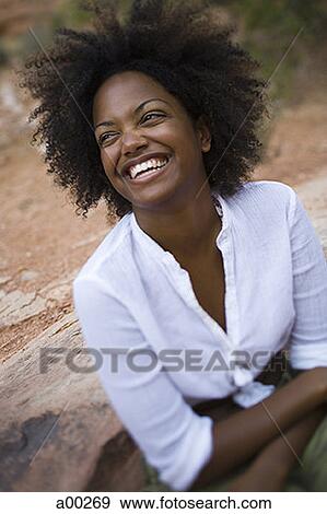 High angle view of a young woman smiling View Large Photo Image Stock Photo - High angle view of a young woman smiling. Fotosearch