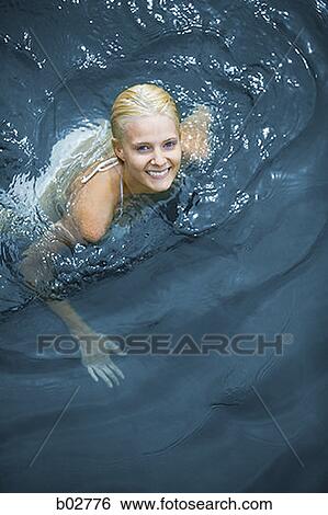 High angle view of a young woman swimming View Large Photo Image Stock Photograph - High angle view of a young woman swimming. Fotosearch